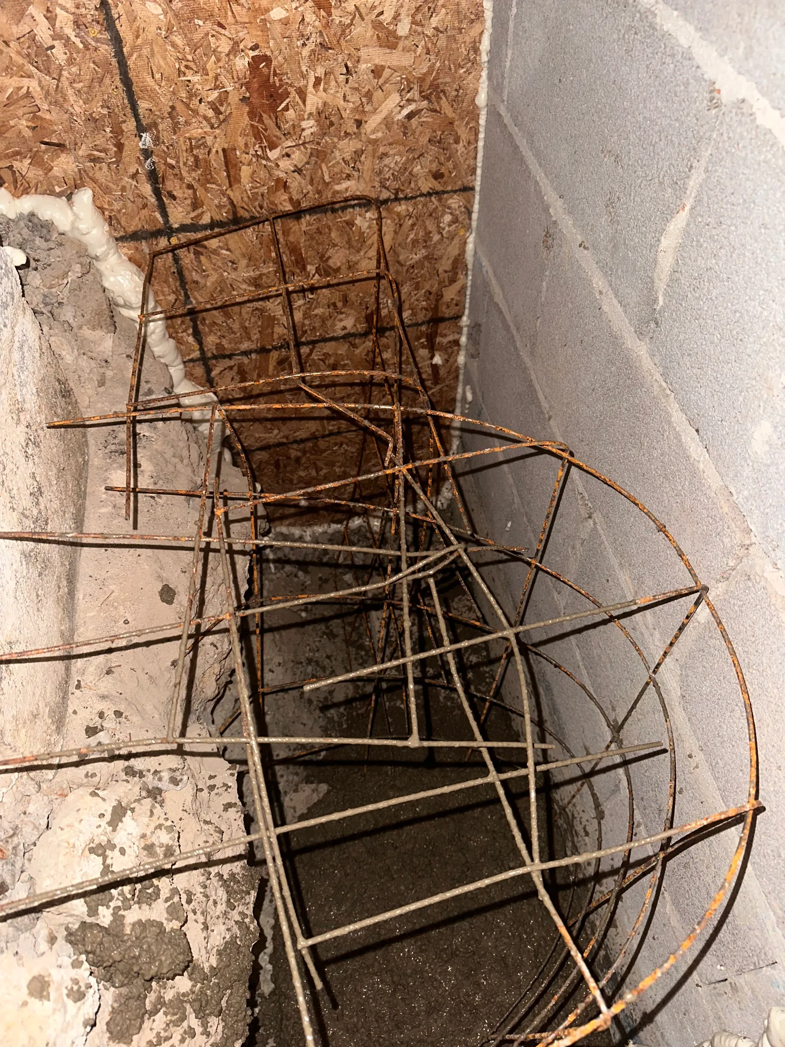 Rebar reinforcement cage positioned at foundation corner before concrete pour